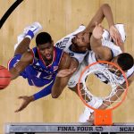 Kansas guard Malik Newman, left, drives to the basket over Villanova's Mikal Bridges, center, and Omari Spellman, right, during the first half in the semifinals of the Final Four NCAA college basketball tournament, Saturday, March 31, 2018, in San Antonio. (AP Photo/David J. Phillip)
