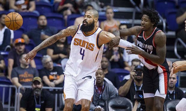 Portland Trail Blazers forward Ed Davis (17) grabs the arm of Phoenix Suns center Tyson Chandler (4...
