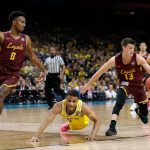 Michigan guard Jaaron Simmons, center, fights for a loose ball with Loyola-Chicago's Donte Ingram, left, and Clayton Custer, right, during the first half in the semifinals of the Final Four NCAA college basketball tournament, Saturday, March 31, 2018, in San Antonio. (AP Photo/Eric Gay)