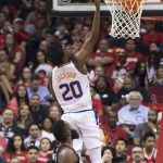 Phoenix Suns guard Josh Jackson (20) lays in a shot in front of Houston Rockets guard James Harden (13) in the first half of an NBA basketball game Friday, March 30, 2018, in Houston. (AP Photo/George Bridges)