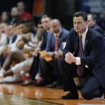 Arizona coach Sean Miller kneels by the bench during the first half of a first-round game against Buffalo in the NCAA men's college basketball tournament Thursday, March 15, 2018, in Boise, Idaho. (AP Photo/Ted S. Warren)