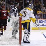 Arizona Coyotes defenseman Kevin Connauton (44) and defenseman Jakob Chychrun (6) celebrate a goal by Coyotes center Christian Dvorak (18) as Nashville Predators goaltender Pekka Rinne (35) pauses near the goal during the second period of an NHL hockey game Thursday, March 15, 2018, in Glendale, Ariz. (AP Photo/Ross D. Franklin)