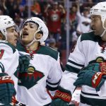 Minnesota Wild left wing Zach Parise (11) celebrates his goal against the Arizona Coyotes with defenseman Jared Spurgeon, center, and left wing Daniel Winnik, right, during the first period of an NHL hockey game Thursday, March 1, 2018, in Glendale, Ariz. (AP Photo/Ross D. Franklin)