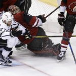 Los Angeles Kings center Jeff Carter (77) collides with Arizona Coyotes goaltender Adin Hill, middle, during overtime of an NHL hockey game Tuesday, March 13, 2018, in Glendale, Ariz. The Coyotes defeated the Kings 4-3 in a shootout. (AP Photo/Ross D. Franklin)