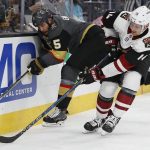 Arizona Coyotes right wing Richard Panik, right, checks Vegas Golden Knights defenseman Deryk Engelland into the boards during the first period of an NHL hockey game, Wednesday, March 28, 2018, in Las Vegas. (AP Photo/John Locher)