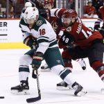 Minnesota Wild left wing Jason Zucker (16) tries to get off a shot as he is hooked by Arizona Coyotes left wing Jordan Martinook (48) during the third period of an NHL hockey game Saturday, March 17, 2018, in Glendale, Ariz. The Wild defeated the Coyotes 3-1. (AP Photo/Ross D. Franklin)