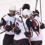 Arizona Coyotes celebrate a goal by Derek Stepan, obscured, during the third period of against the Vancouver Canucks during an NHL hockey game Wednesday, March 7, 2018, in Vancouver, British Columbia. (Jonathan Hayward/The Canadian Press via AP)