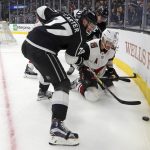 Los Angeles Kings center Jeff Carter (77) and teammate Anze Kopitar, rear, and Arizona Coyotes defenseman Oliver Ekman-Larsson (23) battle in the corner during the second period of an NHL hockey game in Los Angeles Thursday, March 29, 2018. (AP Photo/Reed Saxon)