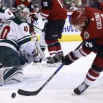 Arizona Coyotes center Nick Cousins (25) is unable to control the puck in front of Minnesota Wild goaltender Devan Dubnyk (40) during the second period of an NHL hockey game Saturday, March 17, 2018, in Glendale, Ariz. The Wild won 3-1. (AP Photo/Ross D. Franklin)
