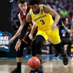 Michigan guard Zavier Simpson (3) runs down a loose ball ahead of Loyola-Chicago guard Clayton Custer during the first half in the semifinals of the Final Four NCAA college basketball tournament, Saturday, March 31, 2018, in San Antonio. (AP Photo/David J. Phillip)