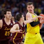 Loyola-Chicago guard Clayton Custer, center, tries to steal the ball from Michigan forward Moritz Wagner, right, during the second half in the semifinals of the Final Four NCAA college basketball tournament, Saturday, March 31, 2018, in San Antonio. (AP Photo/Eric Gay)