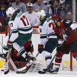 Minnesota Wild left wing Marcus Foligno (17) jumps out of the way of the puck as Arizona Coyotes goaltender Antti Raanta (32) makes a save while Wild left wing Daniel Winnik (26) and Coyotes defenseman Jason Demers (55) watch during the second period of an NHL hockey game Saturday, March 17, 2018, in Glendale, Ariz. The Wild won 3-1. (AP Photo/Ross D. Franklin)