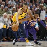 Phoenix Suns guard Shaquille Harrison (10) and Utah Jazz guard Dante Exum (11) reach for the ball during the second half of an NBA basketball game Thursday, March 15, 2018, in Salt Lake City. (AP Photo/Rick Bowmer)