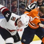 Arizona Coyotes' Max Domi (16) and Edmonton Oilers' Drake Caggiula (91) fight during second-period NHL hockey game action in Edmonton, Alberta, Monday, March 5, 2018. (Jason Franson/The Canadian Press via AP)