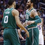 Boston Celtics forward Jayson Tatum (0) celebrates his score against the Phoenix Suns with teammate Abdel Nader, right, during the second half of an NBA basketball game, Monday, March 26, 2018, in Phoenix. The Celtics defeated the Suns 102-94. (AP Photo/Ross D. Franklin)