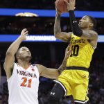 UMBC's Jairus Lyles (10) shoots over Virginia's Isaiah Wilkins (21) during the second half of a first-round game in the NCAA men's college basketball tournament in Charlotte, N.C., Friday, March 16, 2018. (AP Photo/Gerry Broome)