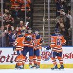 Edmonton Oilers' Andrej Sekera (2), Milan Lucic (27), Connor McDavid (97) and Matthew Benning (83) celebrate a goal against the Arizona Coyotes during first period NHL hockey action in Edmonton, Alberta, Monday, March 5, 2018. (Jason Franson/The Canadian Press via AP)