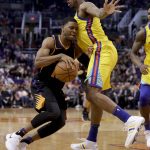 Phoenix Suns guard Shaquille Harrison, left, drives around Golden State Warriors guard Nick Young during the second half of an NBA basketball game in Phoenix, Saturday, March 17, 2018. (AP Photo/Chris Carlson)