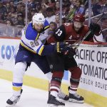 St. Louis Blues center Kyle Brodziak and Arizona Coyotes defenseman Alex Goligoski (33) battle for the puck in the first period during an NHL hockey game, Saturday, March 31, 2018, in Glendale, Ariz. (AP Photo/Rick Scuteri)