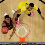 Loyola-Chicago forward Aundre Jackson, left, drives to the basket past Michigan guard Muhammad-Ali Abdur-Rahkman during the first half in the semifinals of the Final Four NCAA college basketball tournament, Saturday, March 31, 2018, in San Antonio. (AP Photo/David J. Phillip)