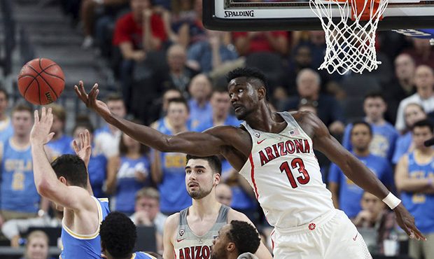 Arizona's Deandre Ayton (13) reaches for a rebound during the second half of the team's NCAA colleg...