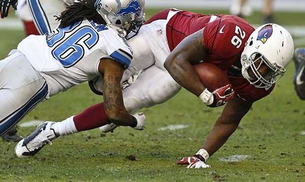 Arizona Cardinals' Beanie Wells (26) dives for some extra yardage as he is brought down by Detroit ...