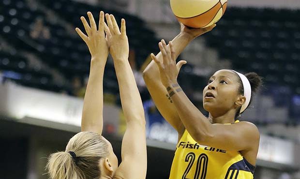 Indiana Fever's Briann January (20) shoots over Phoenix Mercury's Penny Taylor (13) during the firs...