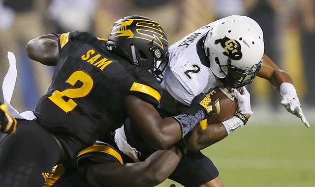 Colorado wide receiver Devin Ross, right, is hit by Arizona State linebacker Christian Sam during t...