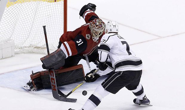 Arizona Coyotes goaltender Adin Hill (31) makes a save on a shot by Los Angeles Kings center Jeff C...