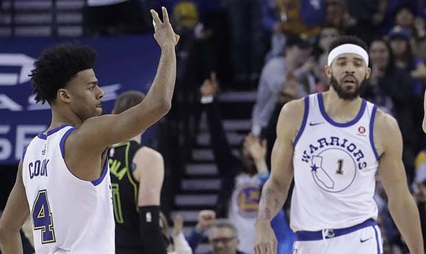 Golden State Warriors guard Stephen Curry (30) celebrates after scoring, with guard Quinn Cook (4) ...