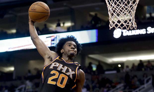 Phoenix Suns guard Josh Jackson, left, shoots over Golden State Warriors center Jordan Bell during ...