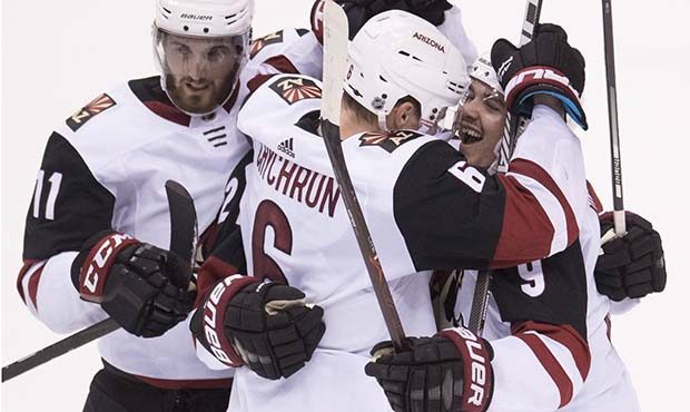 Arizona Coyotes celebrate a goal by Derek Stepan, obscured, during the third period of against the ...