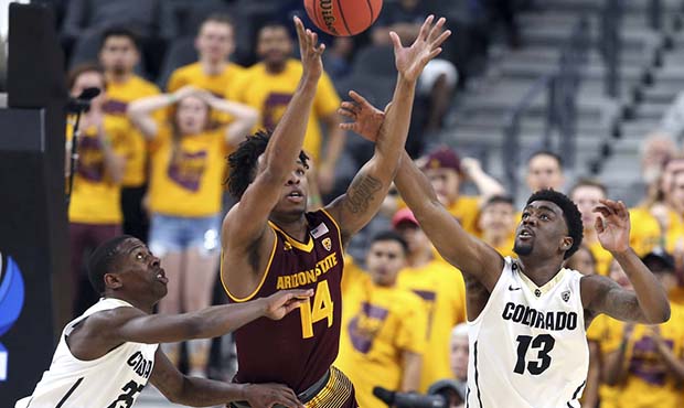 Arizona State's Kimani Lawrence (14), along with Colorado's McKinley Wright IV (25) and Namon Wrigh...