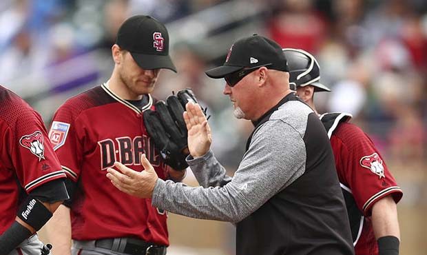 Arizona Diamondbacks pitching coach Mike Butcher, right, visits pitcher Matt Koch, center, during t...
