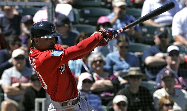 Boston Red Sox's Mookie Betts follows through on his RBI single off Minnesota Twins' Tyler Duffey d...