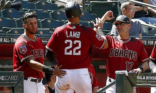 Arizona Diamondbacks' Jake Lamb (22) celebrates his run scored against the Cleveland Indians with D...