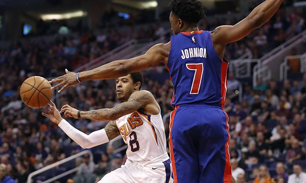 Phoenix Suns guard Tyler Ulis (8) passes the ball as Detroit Pistons forward Stanley Johnson (7) de...