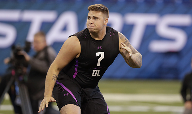 Michigan offensive lineman Mason Cole runs a drill at the NFL football scouting combine in Indianap...