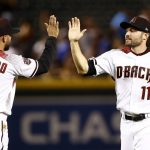 Arizona Diamondbacks' A.J. Pollock (11), who had three home runs on the night, celebrates with Deven Marrero (10) after the final out in the ninth inning of a baseball game against the Los Angeles Dodgers, Monday, April 30, 2018, in Phoenix. The Diamondbacks defeated the Dodgers 8-5. (AP Photo/Ross D. Franklin)