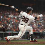 San Francisco Giants' Buster Posey swings for a two run home run off Arizona Diamondbacks' Robbie Ray in the fifth inning of a baseball game Wednesday, April 11, 2018, in San Francisco. (AP Photo/Ben Margot)