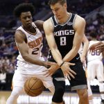 Phoenix Suns forward Danuel House Jr. (23) knocks the ball loose from Sacramento Kings guard Bogdan Bogdanovic (8) during the first half of an NBA basketball game Tuesday, April 3, 2018, in Phoenix. (AP Photo/Matt York)