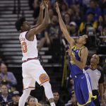 Phoenix Suns' Josh Jackson, left, shoots over Golden State Warriors' Shaun Livingston during the first half of an NBA basketball game Sunday, April 1, 2018, in Oakland, Calif. (AP Photo/Marcio Jose Sanchez)