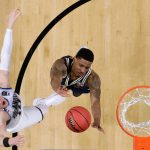 Villanova guard Donte DiVincenzo, left, drives to the basket over Michigan guard Charles Matthews during the second half in the championship game of the Final Four NCAA college basketball tournament, Monday, April 2, 2018, in San Antonio. (AP Photo/David J. Phillip)