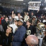 UTSA's Marcus Davenport, center, celebrates by taking a selfie with New Orleans Saints fans after being selected by the team during the first round of the NFL football draft, Thursday, April 26, 2018, in Arlington, Texas. (AP Photo/Michael Ainsworth)