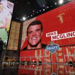 A fan poses with a team jersey and Commissioner Roger Goodell after Notre Dame's Mike McGlinchey was selected by the San Francisco 49ers during the first round of the NFL football draft, Thursday, April 26, 2018, in Arlington, Texas. (AP Photo/David J. Phillip)
