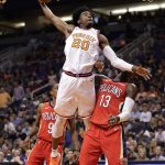 Phoenix Suns guard Josh Jackson (20) dunks over New Orleans Pelicans forward Cheick Diallo (13) during the second half of an NBA basketball game Friday, April 6, 2018, in Phoenix. (AP Photo/Matt York)