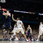 Michigan's Moritz Wagner (13) goes up for a shot past Villanova's Omari Spellman (14) during the second half in the championship game of the Final Four NCAA college basketball tournament, Monday, April 2, 2018, in San Antonio. (AP Photo/Eric Gay)