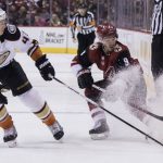 Phoenix Coyotes' Clayton Keller, right, throws up some ice as he protects the puck from Anaheim Ducks' Josh Montour during the second period of an NHL hockey game Saturday, April 7, 2018, in Glendale, Ariz. (AP Photo/Darryl Webb