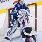 Arizona Coyotes' Dylan Strome, right, crashes into Vancouver Canucks goalie Jacob Markstrom, of Sweden, during the second period of an NHL hockey game Thursday, April 5, 2018, in Vancouver, British Columbia. (Darryl Dyck/The Canadian Press via AP)