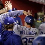 Los Angeles Dodgers' Cody Bellinger (35) celebrates in the dugout after scoring against the Arizona Diamondbacks during the 15th inning of a baseball game Tuesday, April 3, 2018, in Phoenix. (AP Photo/Matt York)